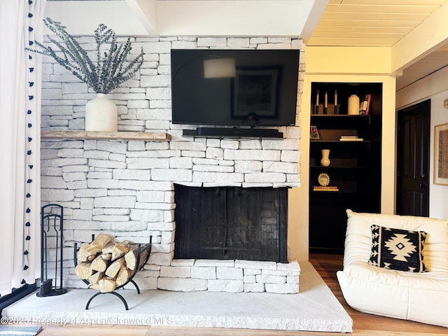 details with built in shelves, wood finished floors, and a fireplace