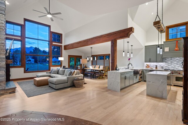 1185 Heritage Dr, Carbondale, CO 81623 - living area with high vaulted ceiling, light wood finished floors, and a ceiling fan