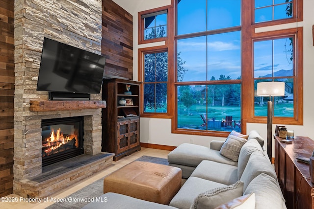 1185 Heritage Dr, Carbondale, CO 81623 - living room featuring a fireplace, wood finished floors, and wood walls