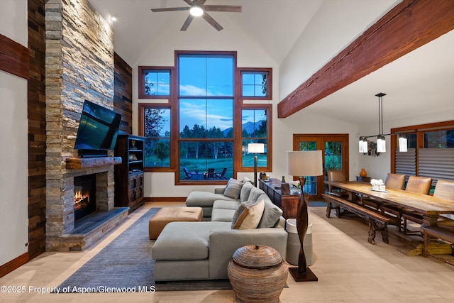 1185 Heritage Dr, Carbondale, CO 81623 - living room featuring a ceiling fan, a stone fireplace, and high vaulted ceiling