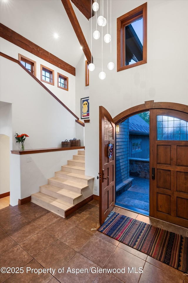 1185 Heritage Dr, Carbondale, CO 81623 - foyer featuring high vaulted ceiling, stairs, and beam ceiling