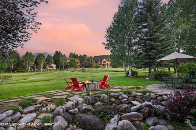 1185 Heritage Dr, Carbondale, CO 81623 - yard at dusk featuring an outdoor fire pit, a patio, a lawn, and a mountain view