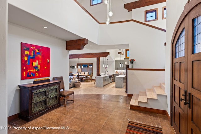 1185 Heritage Dr, Carbondale, CO 81623 - entrance foyer with stairway, a towering ceiling, and tile patterned flooring