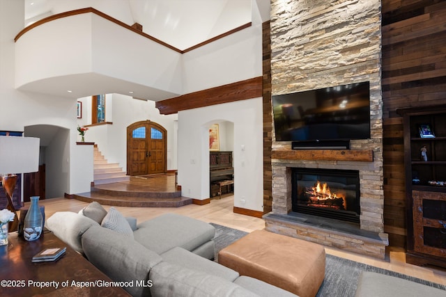 1185 Heritage Dr, Carbondale, CO 81623 - living room with a fireplace, a towering ceiling, wood finished floors, stairway, and arched walkways