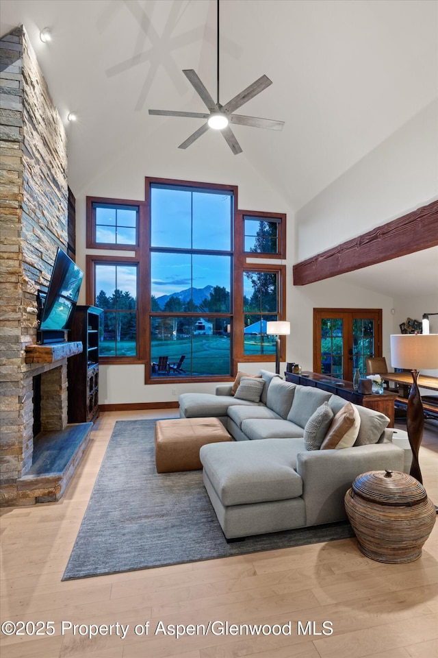 1185 Heritage Dr, Carbondale, CO 81623 - living area featuring high vaulted ceiling, wood finished floors, ceiling fan, a fireplace, and beam ceiling