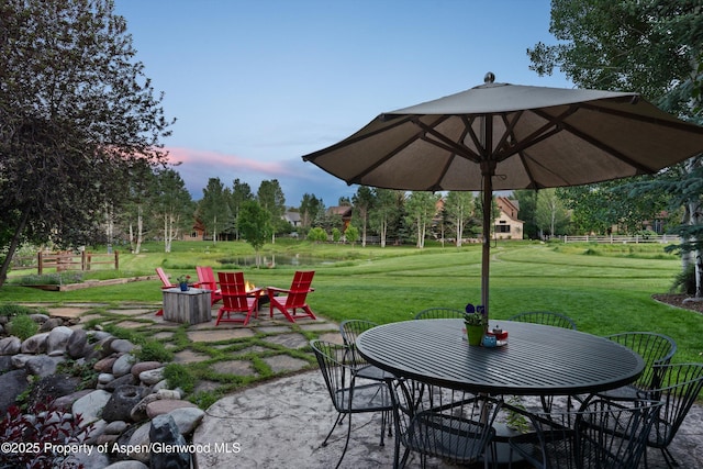 1185 Heritage Dr, Carbondale, CO 81623 - patio terrace at dusk with a patio, a lawn, and outdoor dining area