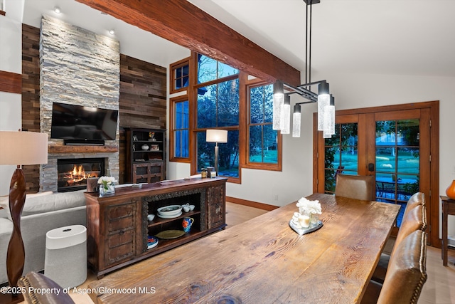 1185 Heritage Dr, Carbondale, CO 81623 - dining room with a stone fireplace, vaulted ceiling, and wood finished floors