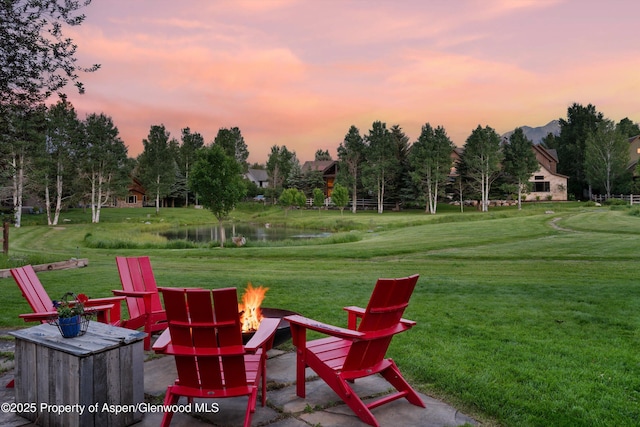 1185 Heritage Dr, Carbondale, CO 81623 - patio terrace at dusk with an outdoor fire pit, a water and mountain view, and a yard