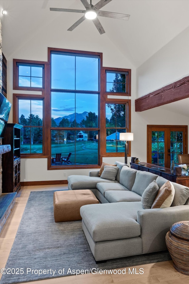 1185 Heritage Dr, Carbondale, CO 81623 - living area with high vaulted ceiling, wood finished floors, a ceiling fan, and french doors