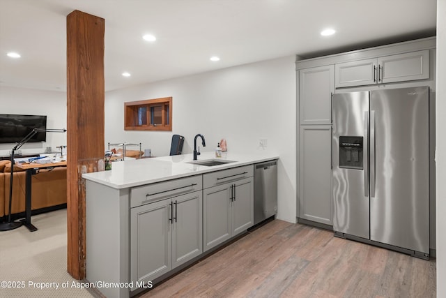 1185 Heritage Dr, Carbondale, CO 81623 - kitchen featuring appliances with stainless steel finishes, gray cabinetry, a peninsula, light wood finished floors, and recessed lighting
