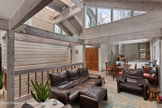 645 Sneaky Ln, Aspen, CO 81611 - living area with beam ceiling, high vaulted ceiling, stairway, plenty of natural light, and wood finished floors