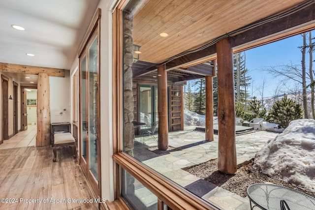 interior space with light hardwood / wood-style flooring and wooden ceiling