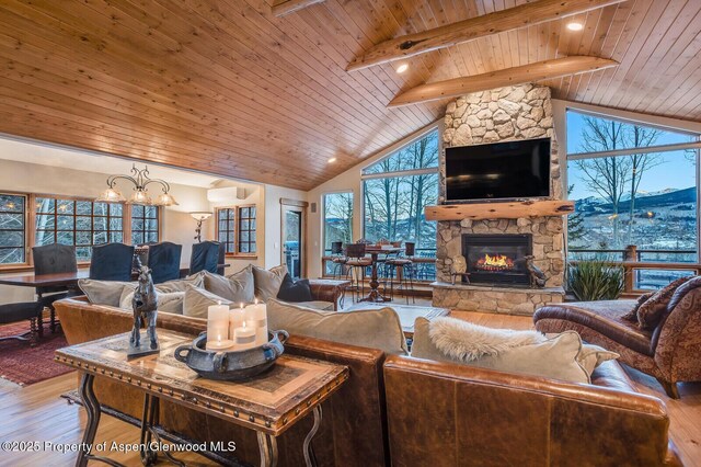 living room featuring hardwood / wood-style flooring, beam ceiling, wooden ceiling, and an inviting chandelier