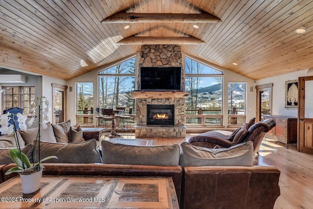 living room with wooden ceiling, beamed ceiling, a wall mounted AC, light hardwood / wood-style floors, and a fireplace