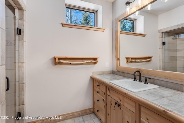 bathroom featuring vanity and a shower with shower door