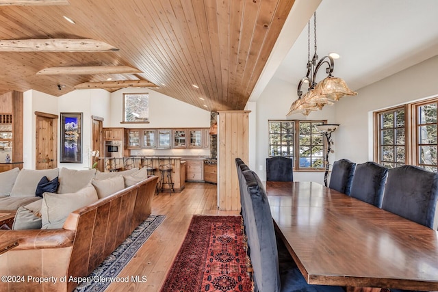 dining area featuring high vaulted ceiling, beamed ceiling, wooden ceiling, and light wood-type flooring