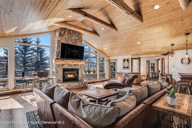 living room with lofted ceiling with beams, wood-type flooring, wood ceiling, and a fireplace