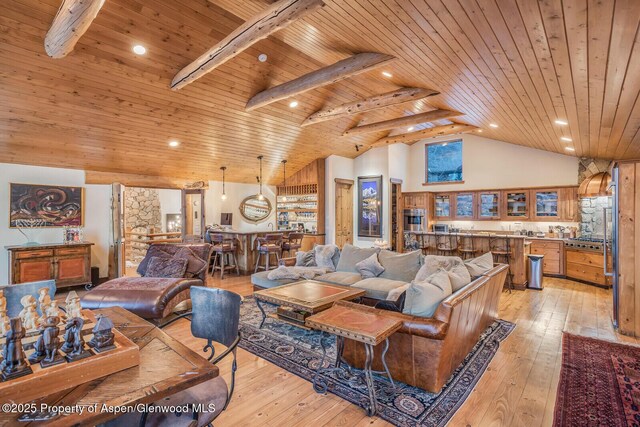 living room featuring french doors, light hardwood / wood-style floors, high vaulted ceiling, and a notable chandelier