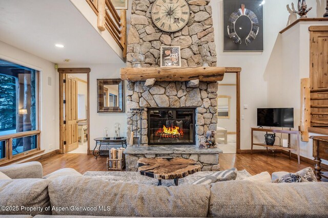 living room with beam ceiling, light hardwood / wood-style floors, high vaulted ceiling, and wooden ceiling