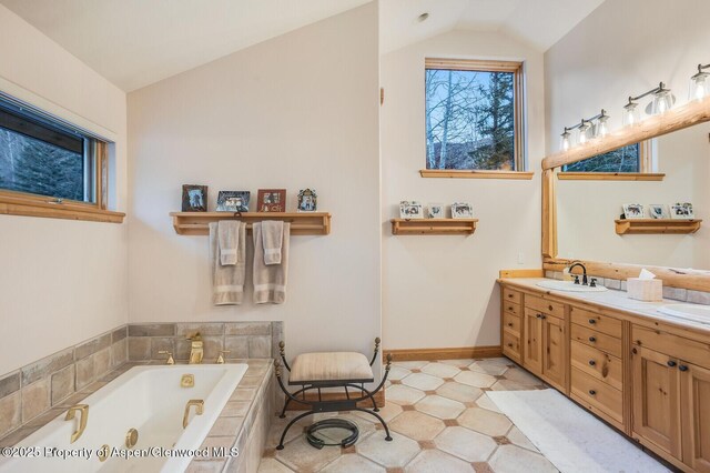 clothes washing area with cabinets, light tile patterned floors, sink, and washing machine and clothes dryer