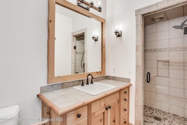 bathroom with vanity, an enclosed shower, and toilet