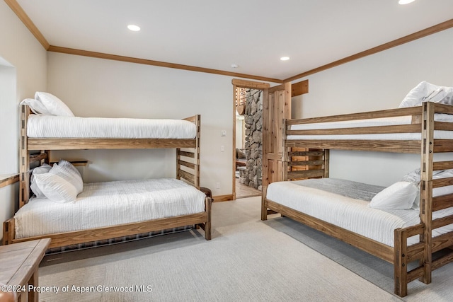 bedroom with crown molding and light carpet