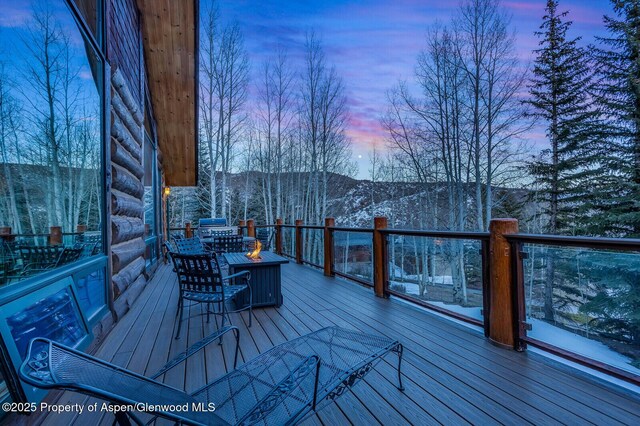 snow covered deck with a mountain view