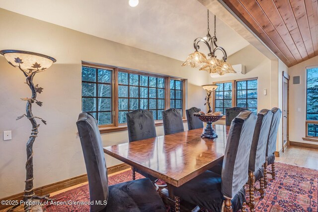 corridor featuring vaulted ceiling with beams, light hardwood / wood-style floors, and a notable chandelier