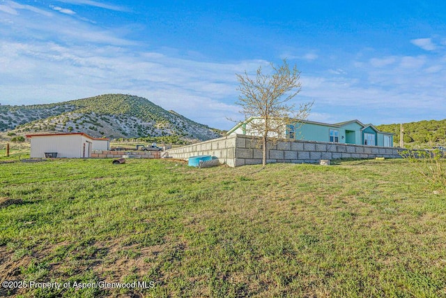 4050 County Road 7, Craig, CO 81625 - view of yard featuring a mountain view, an outdoor structure, and a storage shed