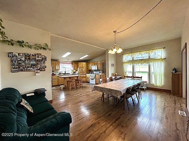 4050 County Road 7, Craig, CO 81625 - dining space with a chandelier and hardwood / wood-style flooring