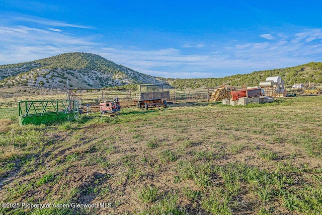 4050 County Road 7, Craig, CO 81625 - view of yard featuring fence, exterior structure, a mountain view, and an outdoor structure