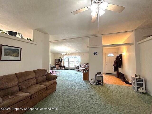 4050 County Road 7, Craig, CO 81625 - living area featuring carpet flooring, a chandelier, and ceiling fan