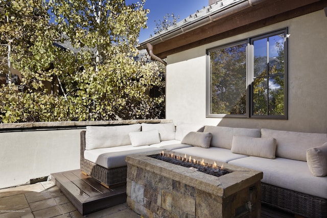 view of patio featuring an outdoor living space with a fire pit