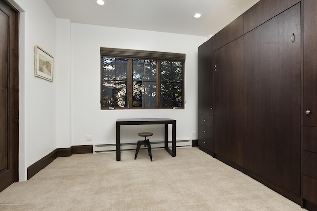 carpeted office space with a baseboard heating unit, recessed lighting, and baseboards