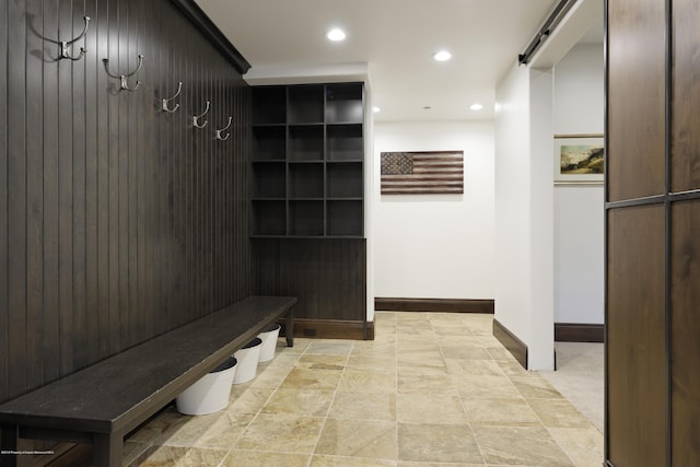 mudroom with a barn door, baseboards, and recessed lighting