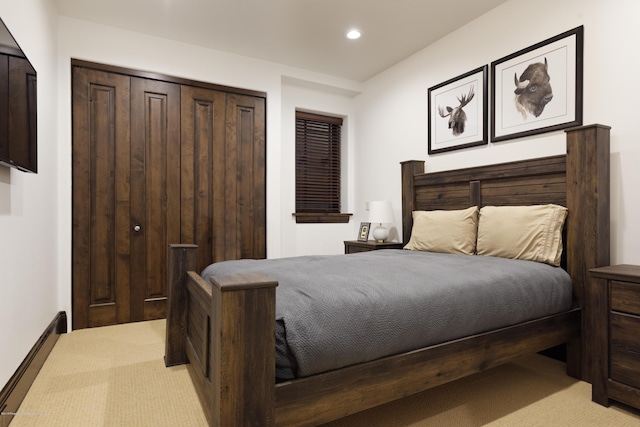 bedroom featuring light carpet, a closet, a baseboard radiator, and recessed lighting