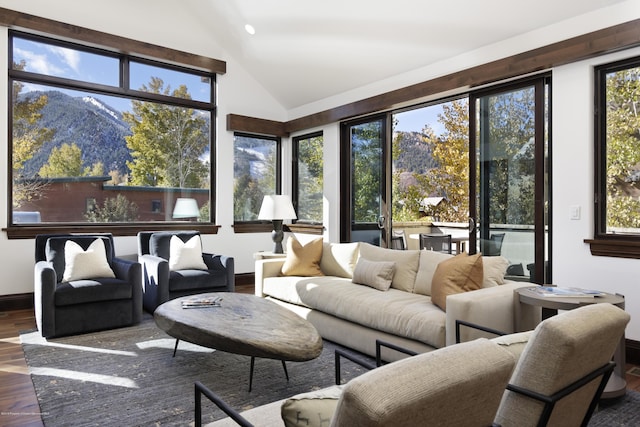 sunroom featuring lofted ceiling and a mountain view