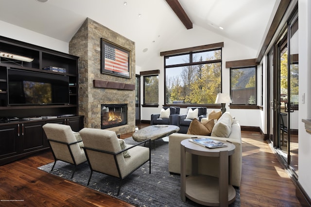 living area with plenty of natural light, a fireplace, dark wood finished floors, and beamed ceiling