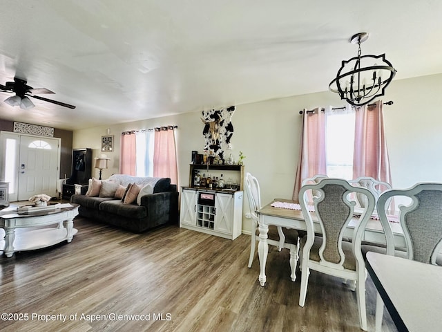 2529 Meadow Cir, Rifle, CO 81650 - living room featuring a chandelier, plenty of natural light, light wood-style floors, and a ceiling fan