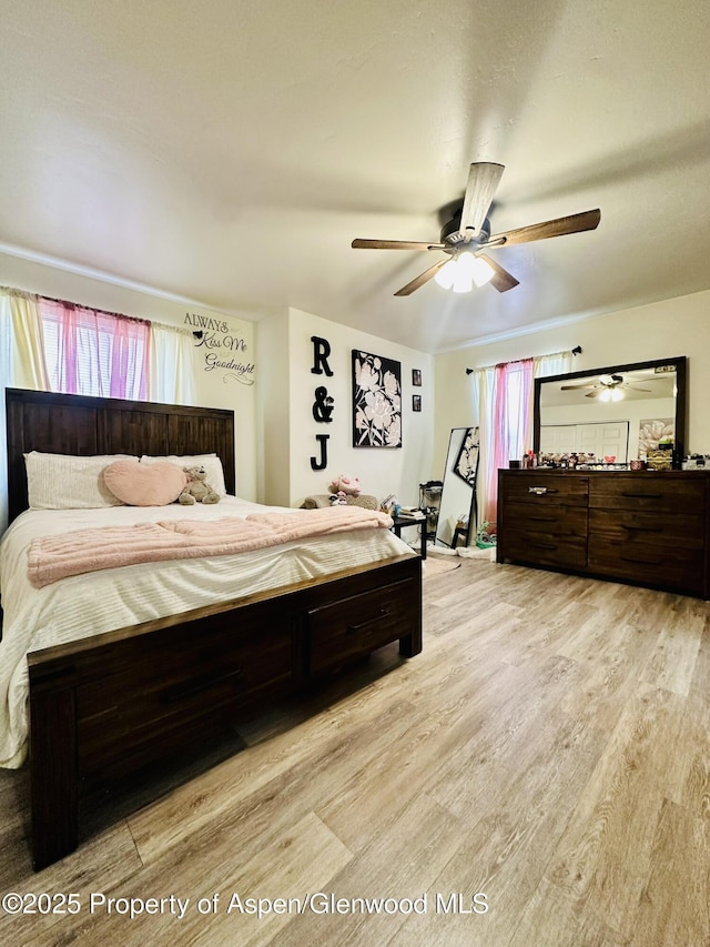 2529 Meadow Cir, Rifle, CO 81650 - bedroom with light wood-style floors, multiple windows, and a ceiling fan