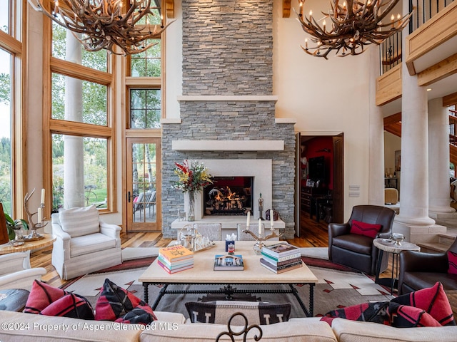 living room featuring a fireplace, wood-type flooring, and a high ceiling