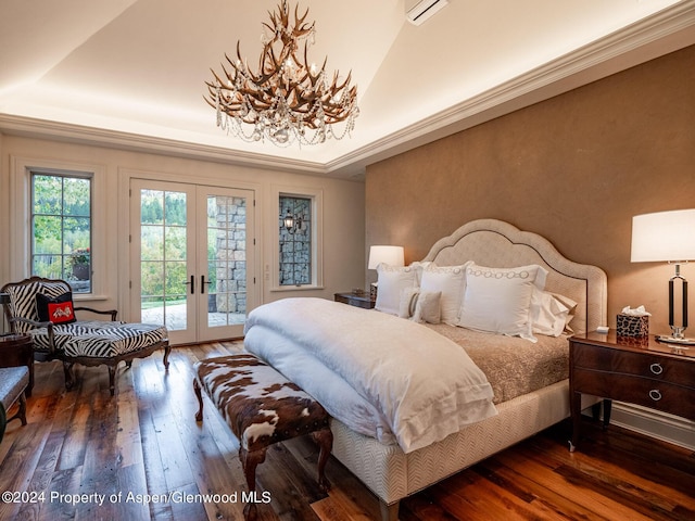 bedroom with a tray ceiling, dark hardwood / wood-style flooring, access to outside, and french doors