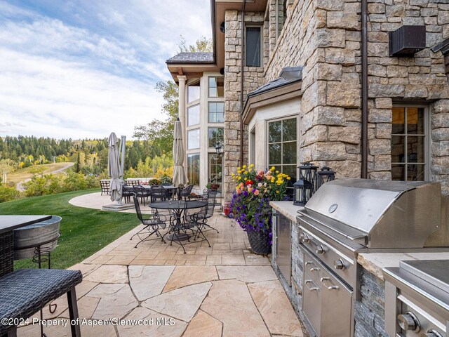 view of patio featuring exterior kitchen and grilling area