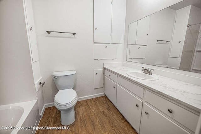 bathroom with vanity, hardwood / wood-style floors, and toilet