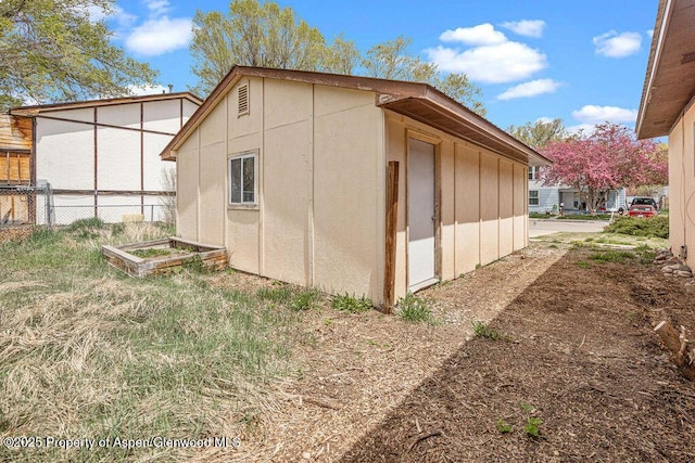 view of outbuilding with fence