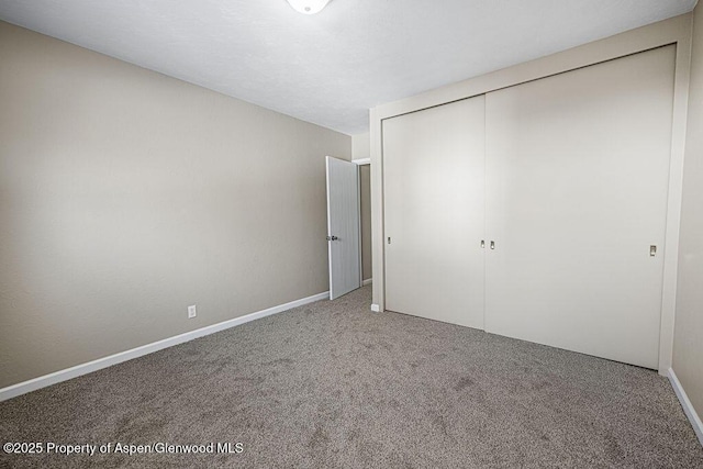 unfurnished bedroom with carpet floors and a closet