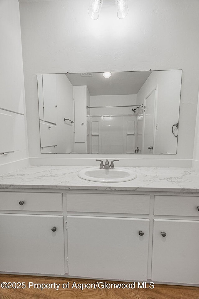 bathroom with vanity and walk in shower