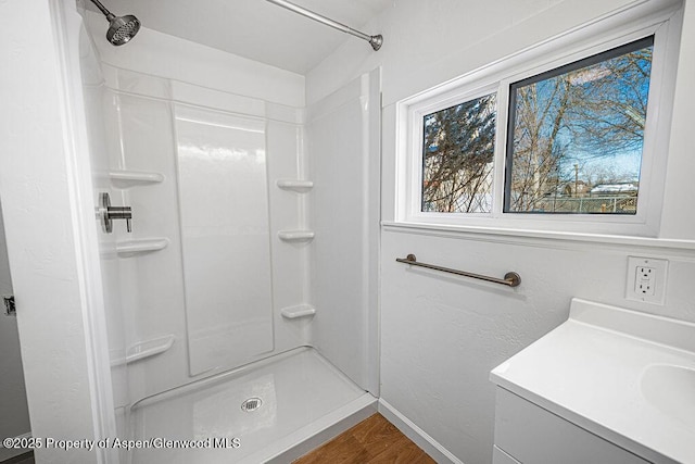 bathroom featuring hardwood / wood-style floors, sink, and walk in shower