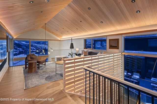 hall with wooden ceiling, lofted ceiling, recessed lighting, wood finished floors, and an upstairs landing