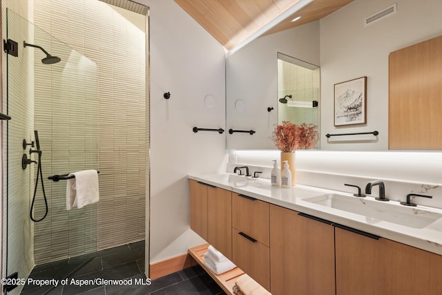 full bath featuring lofted ceiling, tile patterned flooring, a walk in shower, and double vanity